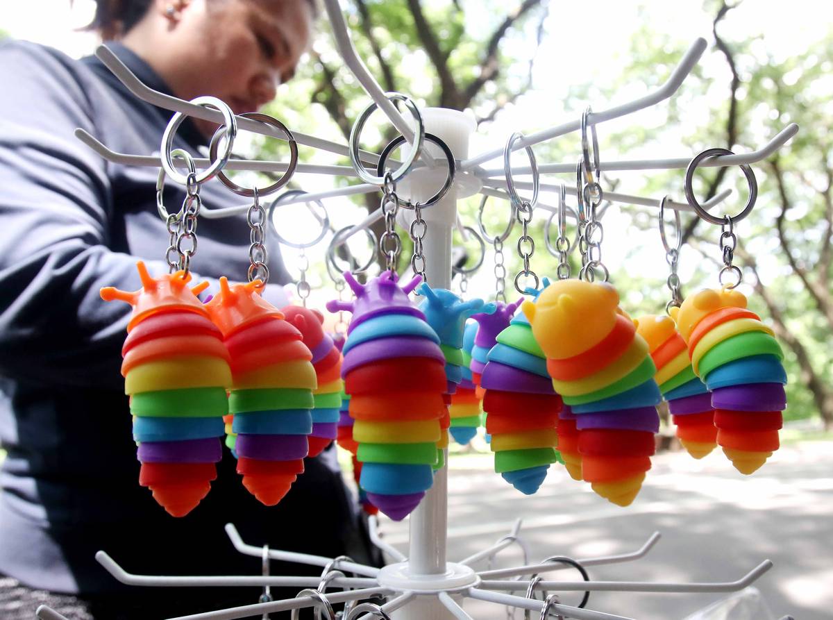 (June 28 2024)………A customer purchased a colorful caterpillar key chain from a stall at the University of the Philippines (UP) in Quezon City. On Friday June 28, 2024………Photo/Analy Labor